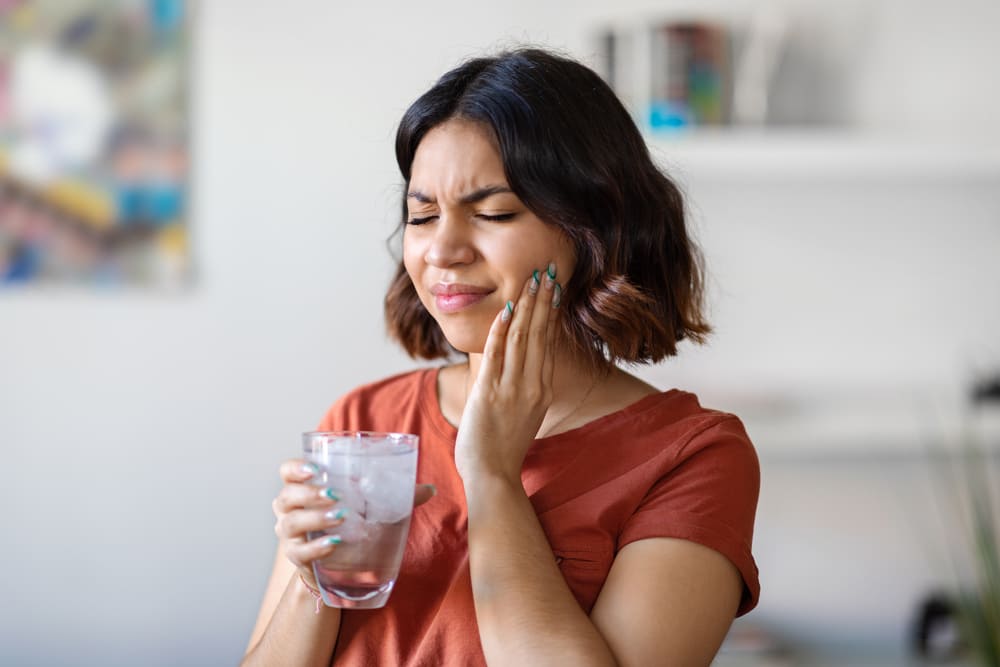 sensitive teeth young arab woman drinking water